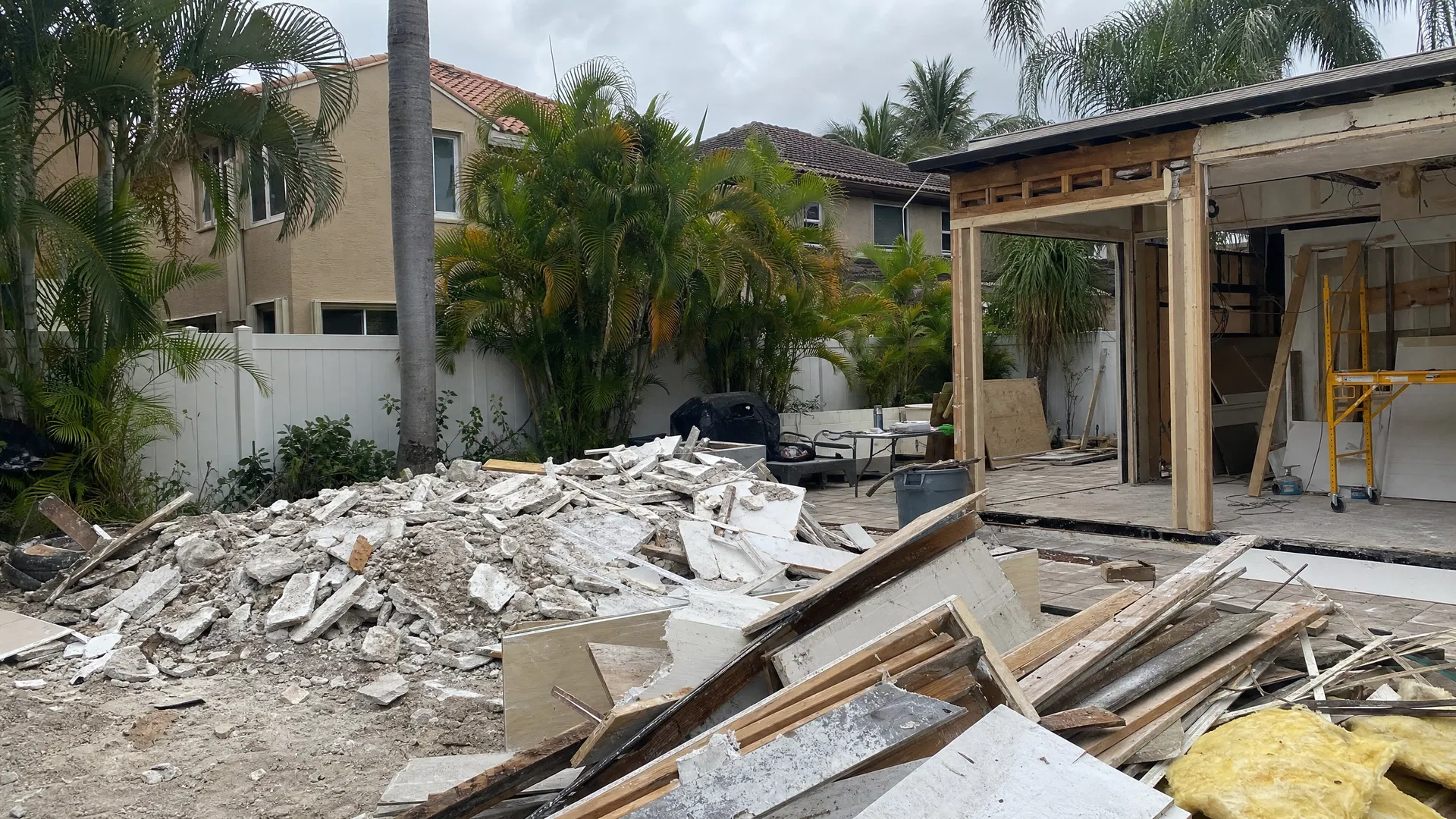 Construction debris piled in backyard before Superior Demo removal in Fort Lauderdale FL
