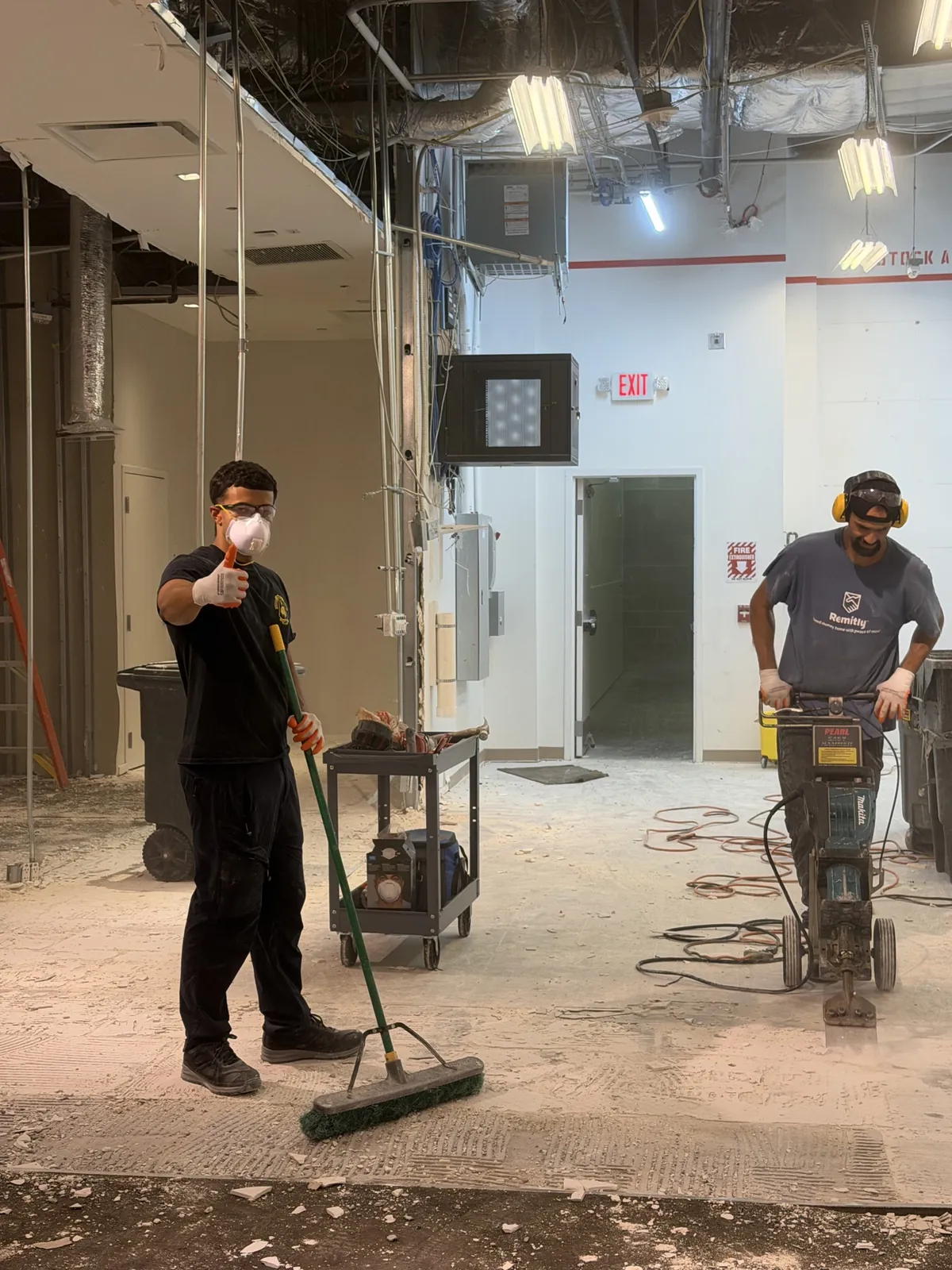 Superior Demo crew removing flooring with a power floor scraper in Broward County FL