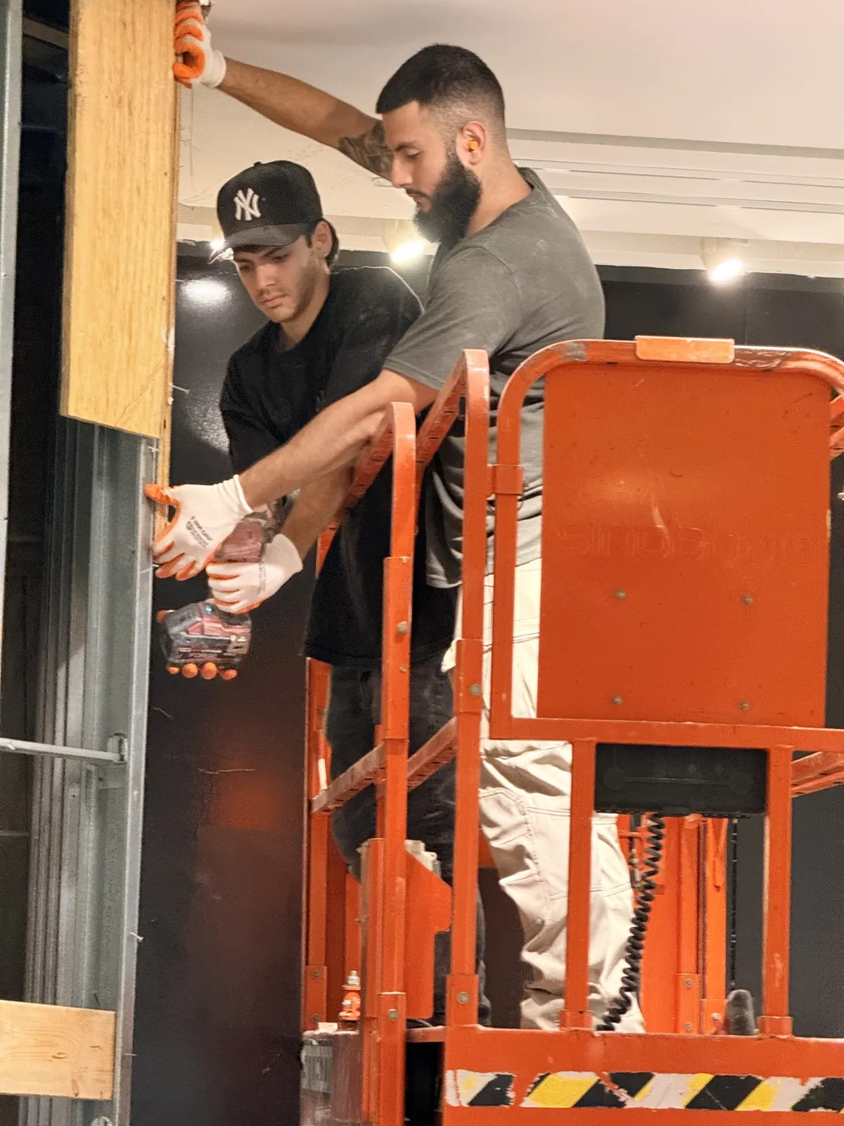 Scissor lift wall demolition during commercial project in Broward County FL
