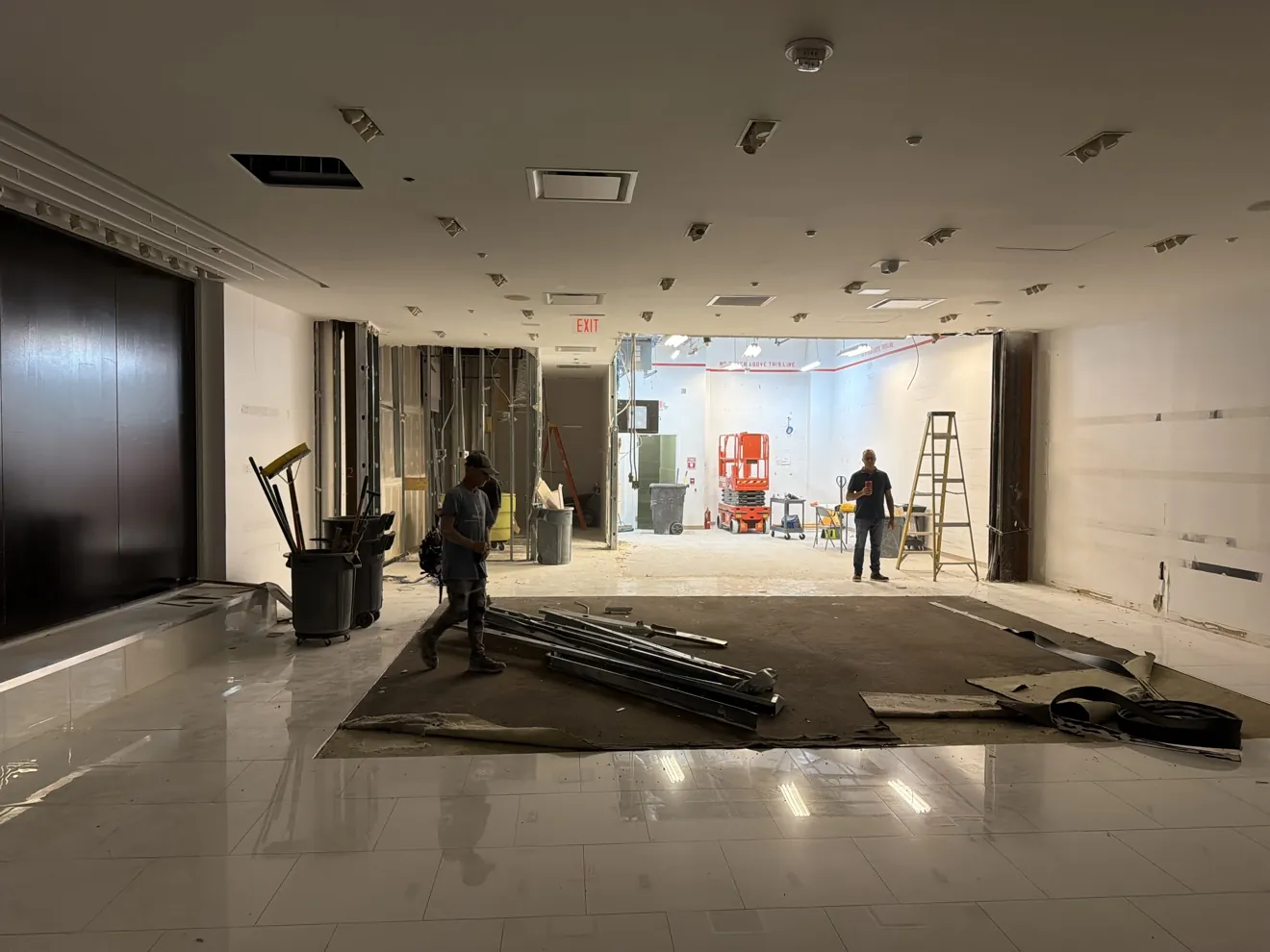 Crew removing large tile flooring during demolition in Broward County FL